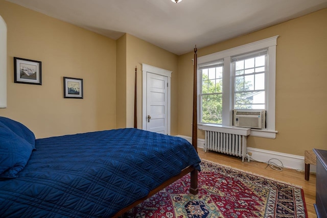 289 Newman Ave, Harrisonburg, VA 22801 - bedroom featuring radiator heating unit, wood finished floors, baseboards, and cooling unit
