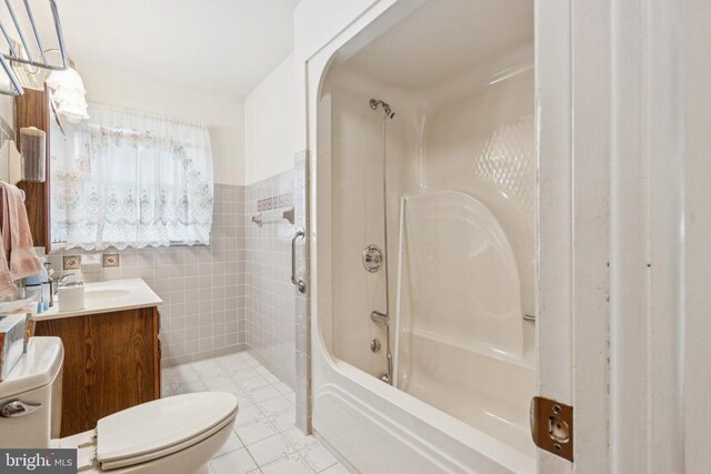  - full bathroom featuring vanity, tile walls, and shower / tub combo