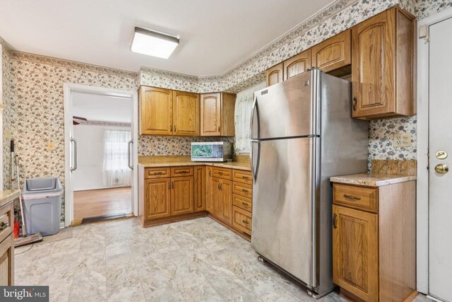  - detailed view of brown cabinetry and light stone counters
