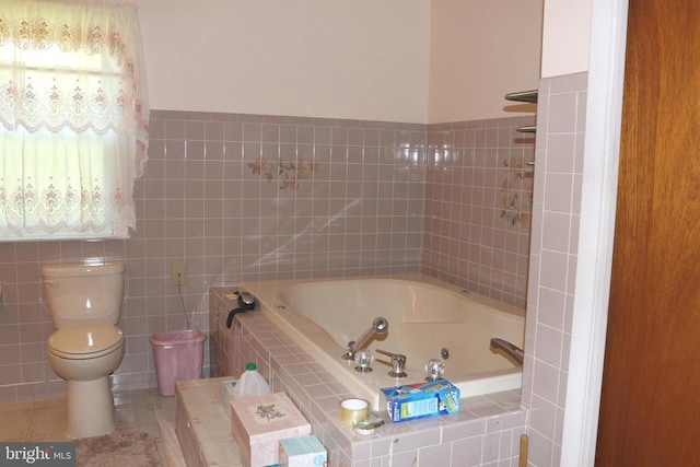  - bathroom featuring a whirlpool tub, tile walls, toilet, and tile patterned floors