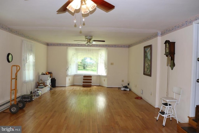  - unfurnished room with ceiling fan, wood finished floors, and baseboards