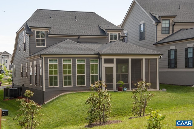back of house with a shingled roof, a lawn, cooling unit, and a sunroom