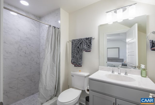 full bathroom with ensuite bathroom, tiled shower, vanity, and toilet