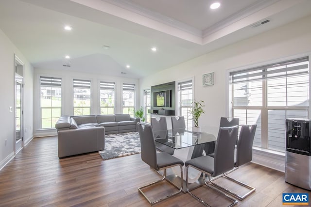 dining area with wood finished floors, recessed lighting, crown molding, lofted ceiling, and baseboards