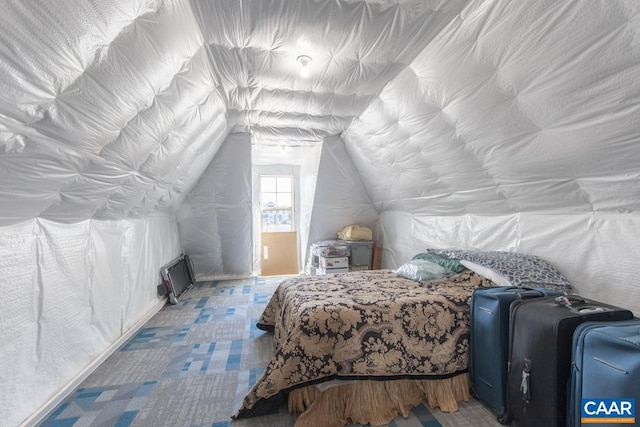 bedroom with vaulted ceiling and tile patterned floors