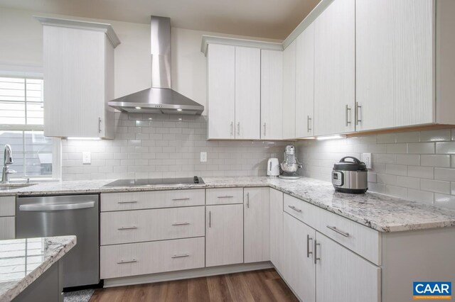 kitchen featuring stainless steel dishwasher, wall chimney exhaust hood, black electric cooktop, a sink, and decorative backsplash