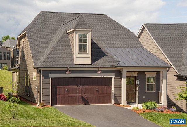 view of front of house featuring asphalt driveway, a shingled roof, and a front yard