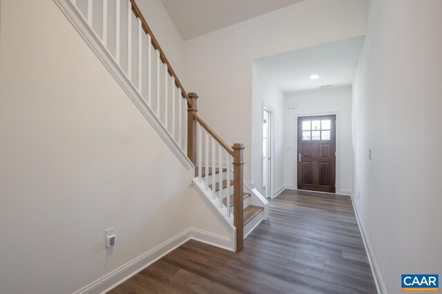 entryway featuring baseboards, dark wood-style floors, stairs, and recessed lighting