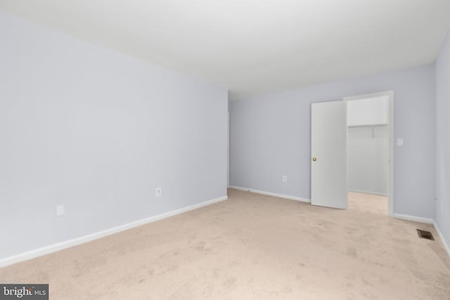 10807 Bent Tree Dr, Fredericksburg, VA 22407 - unfurnished bedroom featuring light colored carpet, a walk in closet, baseboards, and a closet