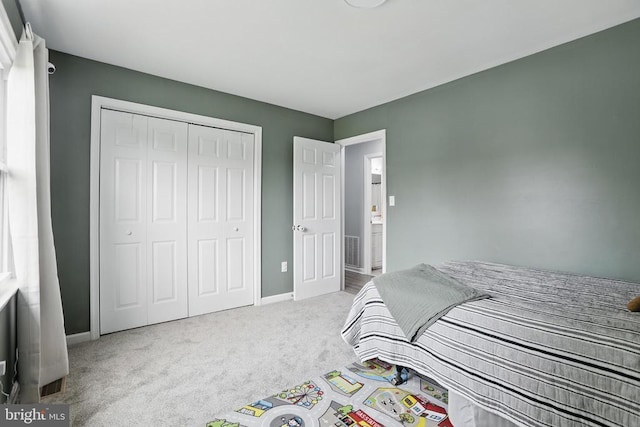 bedroom with carpet, baseboards, and a closet