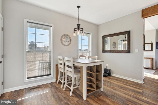 6800 Lake Pointe Dr, Mineral, VA 23117 - dining space featuring baseboards, a chandelier, and wood finished floors