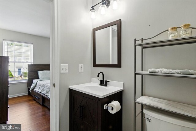 7688 Wankoma Dr, Remington, VA 22734 - bathroom with wood finished floors, vanity, toilet, and baseboards