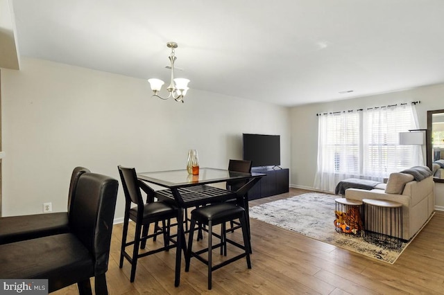 7688 Wankoma Dr, Remington, VA 22734 - dining area featuring a chandelier, wood finished floors, and baseboards