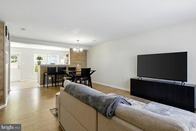7688 Wankoma Dr, Remington, VA 22734 - living area with a chandelier, baseboards, and light wood-style floors
