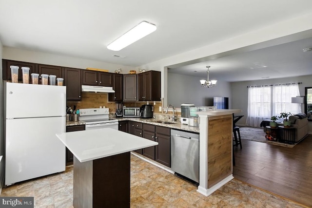 7688 Wankoma Dr, Remington, VA 22734 - kitchen featuring appliances with stainless steel finishes, a sink, under cabinet range hood, open floor plan, and light countertops