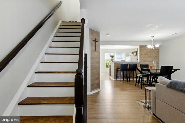 7688 Wankoma Dr, Remington, VA 22734 - stairs with wood finished floors and a chandelier