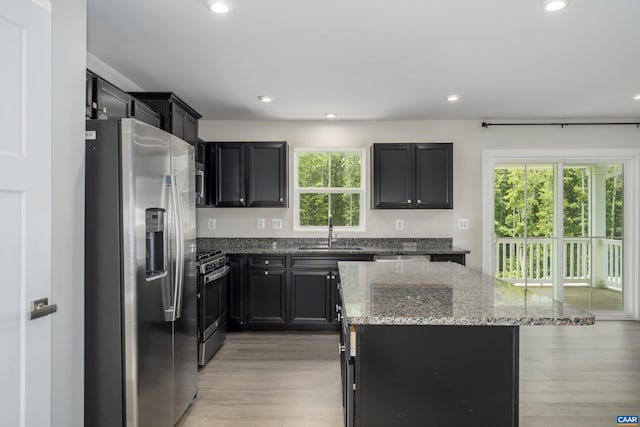 107 Archer Dr, Palmyra, VA 22963 - kitchen with stainless steel appliances, a kitchen island, light stone counters, dark cabinetry, and recessed lighting