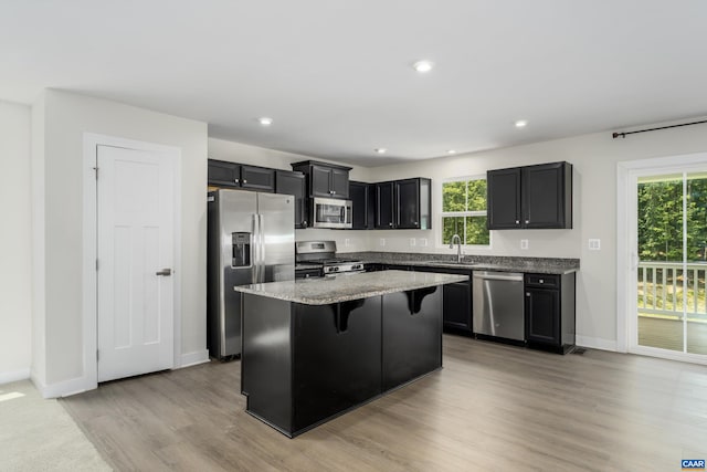 107 Archer Dr, Palmyra, VA 22963 - kitchen with appliances with stainless steel finishes, a kitchen bar, healthy amount of natural light, a kitchen island, and recessed lighting