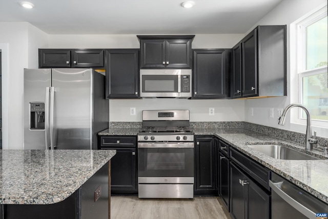 107 Archer Dr, Palmyra, VA 22963 - kitchen with stainless steel appliances, dark stone countertops, dark cabinets, recessed lighting, and light wood finished floors