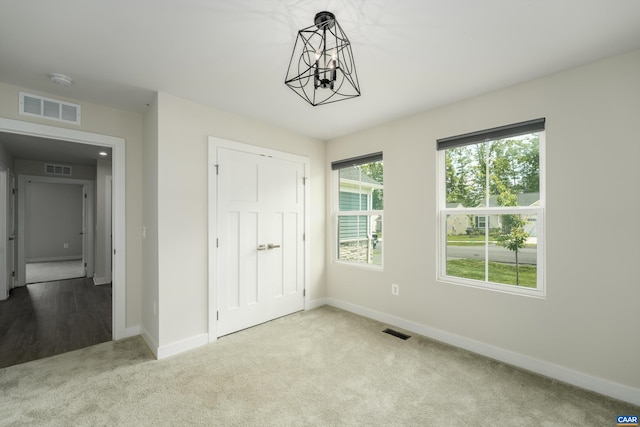 107 Archer Dr, Palmyra, VA 22963 - unfurnished bedroom with carpet flooring, a closet, and a chandelier