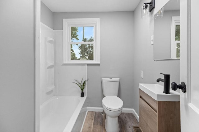14372 E Side Hwy S, Grottoes, VA 24401 - full bath with toilet, vanity, wood finished floors, baseboards, and bathing tub / shower combination