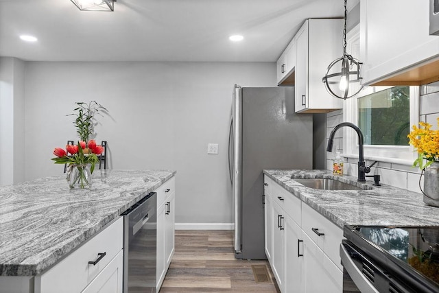 14372 E Side Hwy S, Grottoes, VA 24401 - kitchen with a sink, stainless steel appliances, light wood-style floors, white cabinets, and light stone countertops