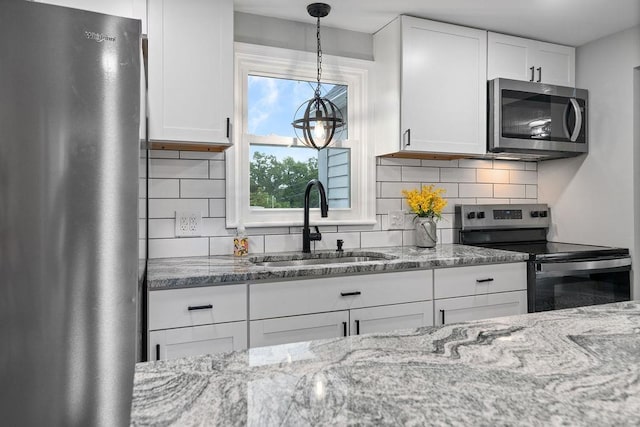 14372 E Side Hwy S, Grottoes, VA 24401 - kitchen featuring stainless steel appliances, a sink, white cabinetry, and light stone countertops