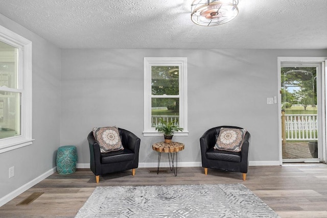 14372 E Side Hwy S, Grottoes, VA 24401 - living area featuring a textured ceiling, wood finished floors, and baseboards