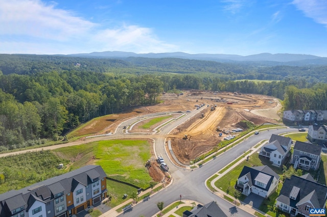 birds eye view of property with a forest view and a mountain view
