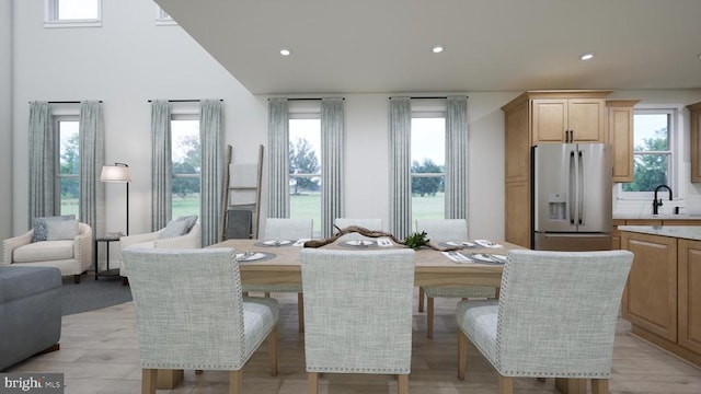 dining area featuring recessed lighting, a healthy amount of sunlight, and light wood-style floors