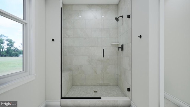 full bath featuring baseboards and a stall shower