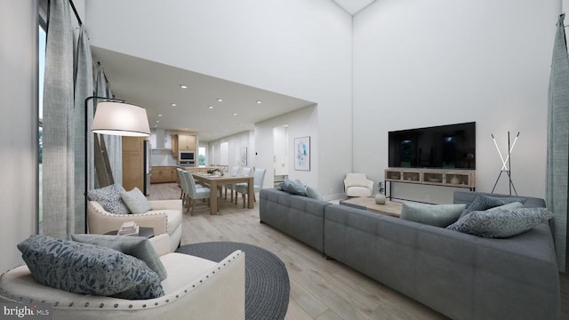 living room with recessed lighting, light wood-style flooring, and a towering ceiling