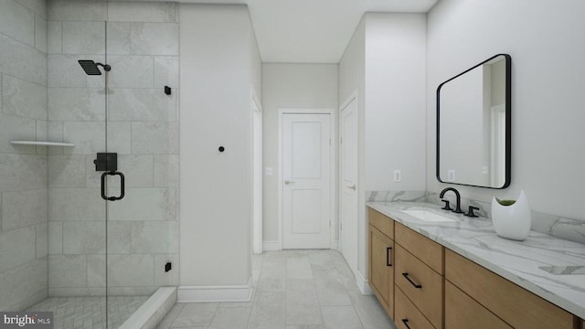 bathroom featuring double vanity, baseboards, a stall shower, and a sink