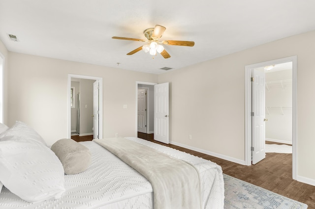740 Confederacy Dr, Penn Laird, VA 22846 - bedroom with wood finished floors, a walk in closet, baseboards, ceiling fan, and a closet