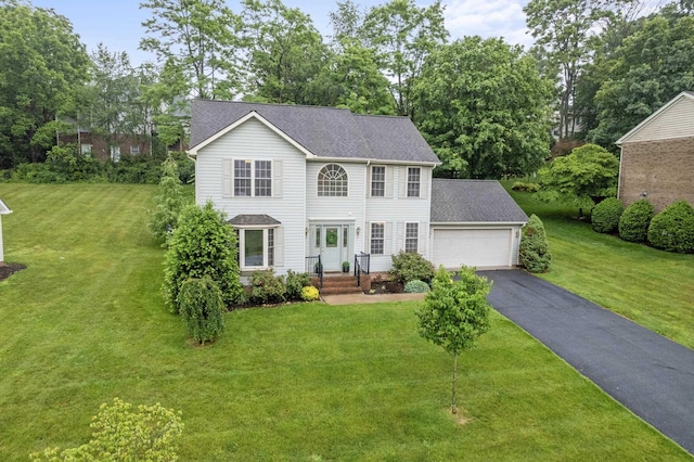 740 Confederacy Dr, Penn Laird, VA 22846 - colonial-style house with driveway, a garage, a front lawn, roof with shingles, and view of wooded area
