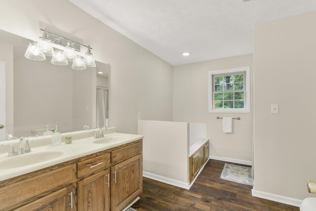 740 Confederacy Dr, Penn Laird, VA 22846 - full bathroom featuring wood finished floors, a garden tub, double vanity, baseboards, and recessed lighting