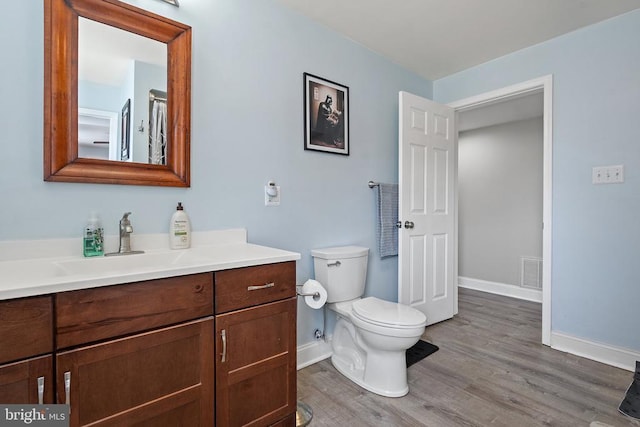 9107 Grasty Gold Mine Rd, Rhoadesville, VA 22542 - full bathroom featuring baseboards, wood finished floors, toilet, and vanity