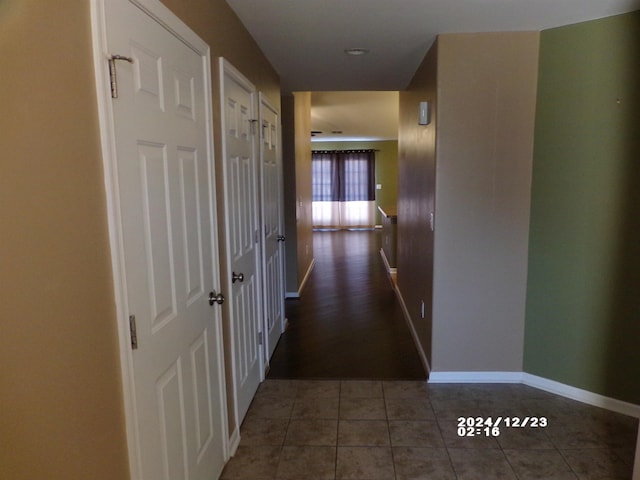 corridor featuring dark tile patterned flooring