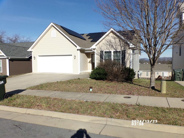 view of front of house featuring a garage and solar panels