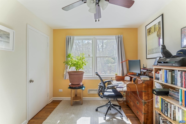 office area featuring wood finished floors, a ceiling fan, and baseboards