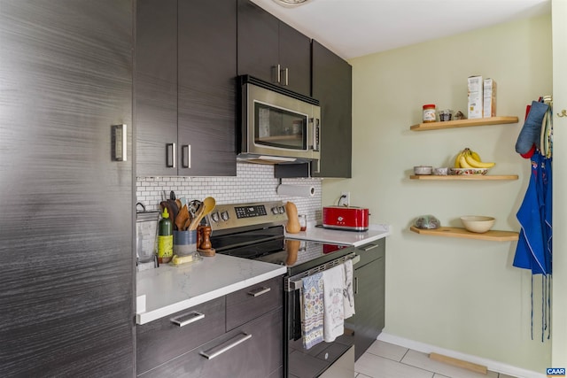 kitchen featuring appliances with stainless steel finishes, decorative backsplash, light countertops, and open shelves