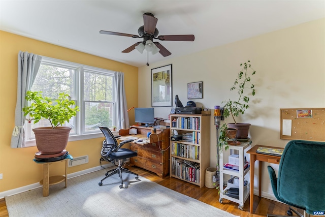 office area with wood finished floors, ceiling fan, and baseboards