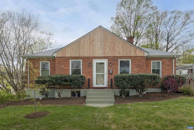 view of front of property with a front lawn, a shingled roof, and a chimney