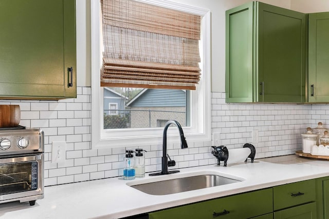 16715 Prospect Ave E, Elkton, VA 22827 - kitchen with green cabinets, a sink, decorative backsplash, and light countertops