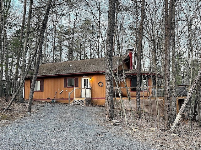 view of front facade featuring roof with shingles