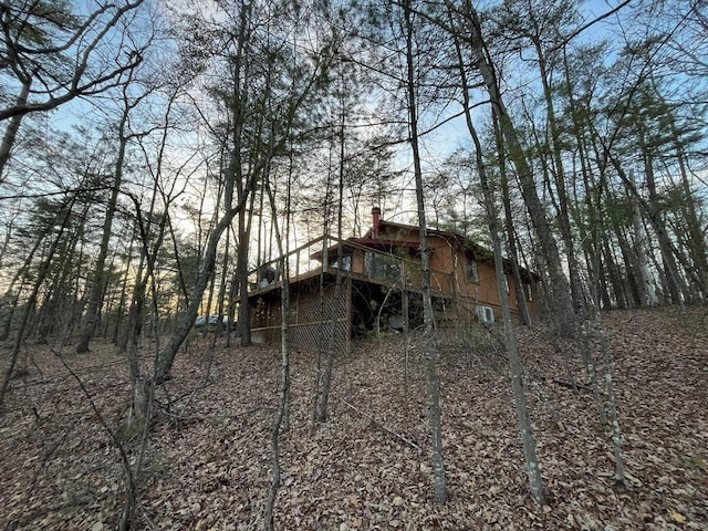 rear view of property featuring a wooden deck