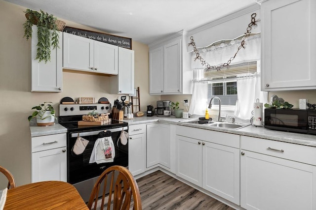 58 Augusta St, Verona, VA 24482 - kitchen featuring electric range, black microwave, light countertops, white cabinets, and light wood-style floors