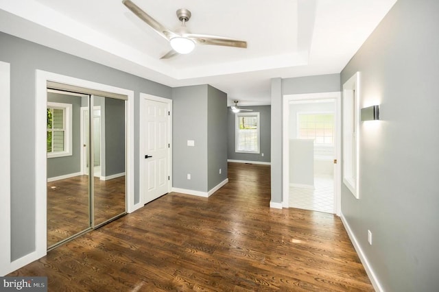 14906 Laurel Point Ln, Spotsylvania, VA 22551 - unfurnished bedroom with a tray ceiling, wood finished floors, a closet, and a ceiling fan