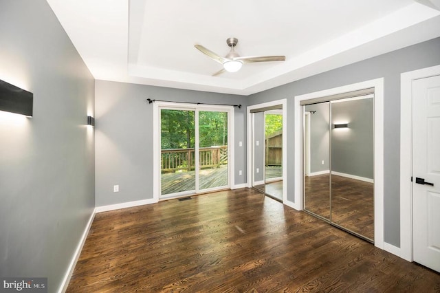 14906 Laurel Point Ln, Spotsylvania, VA 22551 - unfurnished bedroom with access to outside, a tray ceiling, wood finished floors, two closets, and ceiling fan