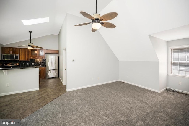 14906 Laurel Point Ln, Spotsylvania, VA 22551 - unfurnished living room featuring a ceiling fan, a skylight, lofted ceiling, and dark colored carpet